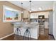 Eat-in kitchen featuring a breakfast bar, pendant lighting, and a view of stainless steel appliances at 12814 Forest Cir, Thornton, CO 80241