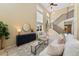 Sunlit living room featuring a soaring ceiling, a staircase and neutral decor with stylish furnishings at 12814 Forest Cir, Thornton, CO 80241