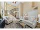 Bright living room showcasing soaring ceilings, a staircase, and neutral décor with comfortable seating at 12814 Forest Cir, Thornton, CO 80241