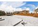 Fenced backyard with trampoline and winter scene at 10081 Truckee St, Commerce City, CO 80022