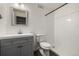 Basement bathroom with grey vanity and walk-in shower at 10081 Truckee St, Commerce City, CO 80022