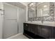 Modern bathroom with double vanity and walk-in shower at 10081 Truckee St, Commerce City, CO 80022