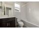 Clean bathroom with bathtub, toilet, and dark vanity at 10081 Truckee St, Commerce City, CO 80022