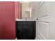 Small bathroom with dark vanity and red accent wall at 10081 Truckee St, Commerce City, CO 80022