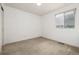 Bright bedroom with a window, carpet, and double-door closet at 10081 Truckee St, Commerce City, CO 80022