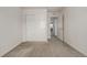 Simple bedroom with carpet, closet, and access to hallway at 10081 Truckee St, Commerce City, CO 80022