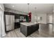 Modern kitchen with island, stainless steel appliances, and backsplash at 10081 Truckee St, Commerce City, CO 80022
