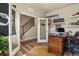 Well-lit home office featuring a glass door, wooden desk, and view of the staircase at 23893 E Minnow Cir, Aurora, CO 80016