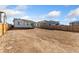 The backyard is spacious and framed by a wooden fence for privacy at 18953 E 97Th Ave, Commerce City, CO 80022
