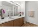 Bright bathroom features double vanity sinks, a large mirror, and modern fixtures at 18953 E 97Th Ave, Commerce City, CO 80022