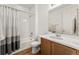 Bathroom with shower-tub combination and vanity with a white countertop and gray accents at 18953 E 97Th Ave, Commerce City, CO 80022