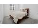 Bedroom with a large bed, a big window, and comfortable carpet at 18953 E 97Th Ave, Commerce City, CO 80022