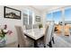 Bright dining area with a marble table, comfortable seating, and access to the outdoor space at 18953 E 97Th Ave, Commerce City, CO 80022