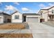 Charming single-story home with a two-car garage and well-manicured lawn at 18953 E 97Th Ave, Commerce City, CO 80022