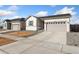 Charming home with a well-kept lawn, a neutral-colored facade, and an attached two-car garage at 18953 E 97Th Ave, Commerce City, CO 80022