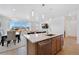 Open floor plan showcases kitchen with island, dining area and living room with large sliding glass doors at 18953 E 97Th Ave, Commerce City, CO 80022