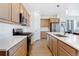Well-equipped kitchen with stainless appliances, ample counter space, and natural wood cabinetry at 18953 E 97Th Ave, Commerce City, CO 80022