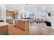 Open-concept kitchen with stainless steel appliances and spacious island overlooking the living area at 18953 E 97Th Ave, Commerce City, CO 80022