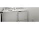 A modern, front-loading washer and dryer sit side-by-side, ready for laundry day at 18953 E 97Th Ave, Commerce City, CO 80022