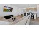 Open floor plan showcases a living room flowing into the kitchen with breakfast bar seating at 18953 E 97Th Ave, Commerce City, CO 80022