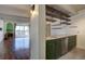 Inviting kitchen and living area featuring stainless steel appliances, exposed shelving, and a fireplace at 777 N Washington St # 802, Denver, CO 80203