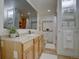 Bathroom featuring a large mirror, vanity, toilet, shower, and shelf at 1825 W 32Nd Ave, Denver, CO 80211