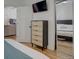 Bedroom featuring a dresser, mirror, and TV at 1825 W 32Nd Ave, Denver, CO 80211