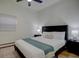 Comfortable bedroom with a ceiling fan, plush bedding, and bedside lamps at 1825 W 32Nd Ave, Denver, CO 80211