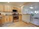 Kitchen with stainless steel appliances, light wood cabinets, and granite counters at 1825 W 32Nd Ave, Denver, CO 80211