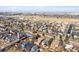 A neighborhood featuring colorful roofs, mature trees, and a well-maintained road network are shown from an aerial perspective at 9140 E 29Th Ave, Denver, CO 80238