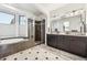 Bathroom featuring a tub, dual sink vanity, and large glass shower enclosure at 9140 E 29Th Ave, Denver, CO 80238