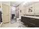 Modern bathroom featuring a glass-enclosed shower, dual sink vanity, and sleek fixtures for a luxurious feel at 9140 E 29Th Ave, Denver, CO 80238