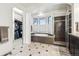 Bathroom featuring a soaking tub, walk-in shower, tile floors, and vanity at 9140 E 29Th Ave, Denver, CO 80238