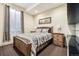 Cozy bedroom with a wooden frame bed, natural light, and bedside tables creating a warm and inviting atmosphere at 9140 E 29Th Ave, Denver, CO 80238