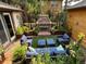 Inviting courtyard featuring an outdoor fireplace, comfortable seating, and lush landscaping at 9140 E 29Th Ave, Denver, CO 80238