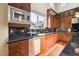 Well-lit kitchen with wooden cabinets, stainless steel appliances, granite countertops and modern backsplash at 9140 E 29Th Ave, Denver, CO 80238