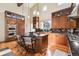 Well-lit kitchen with a large island, stainless steel appliances, granite counters, and wooden cabinets at 9140 E 29Th Ave, Denver, CO 80238