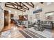 Open-concept living space with wood floors, exposed beams, and a modern kitchen at 9140 E 29Th Ave, Denver, CO 80238