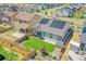 Aerial view of a home with solar panels, fenced yard and a backyard storage shed at 4040 Eaton Park St, Aurora, CO 80019