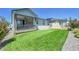 Spacious landscaped backyard with green lawn, wooden fence, and storage shed at 4040 Eaton Park St, Aurora, CO 80019
