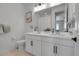 Bright bathroom with double sink vanity, modern lighting and neutral tile at 4040 Eaton Park St, Aurora, CO 80019