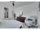 Comfortable bedroom features a ceiling fan, accent chair, and a dresser with decorative elements at 4040 Eaton Park St, Aurora, CO 80019