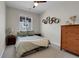 Stylish bedroom with bed, dresser, ceiling fan and window at 4040 Eaton Park St, Aurora, CO 80019