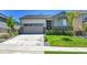 Charming single-Gathering home features a two-car garage, stone accents, and a well-manicured lawn at 4040 Eaton Park St, Aurora, CO 80019