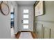 Bright foyer with stylish decor, featuring paneled walls, and a modern front door with frosted windows at 4040 Eaton Park St, Aurora, CO 80019