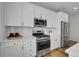 Kitchen featuring stainless steel appliances, white cabinets, subway tile backsplash, and gas range at 4040 Eaton Park St, Aurora, CO 80019