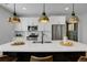 Well-lit kitchen island with white countertops, modern fixtures, and stainless steel appliances; great for cooking at 4040 Eaton Park St, Aurora, CO 80019