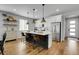 Modern kitchen with a center island, pendant lighting, stainless steel appliances, and stylish counter chairs at 4040 Eaton Park St, Aurora, CO 80019