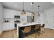 Bright kitchen features a large island with seating, modern appliances, and plenty of counter space; cooking haven at 4040 Eaton Park St, Aurora, CO 80019