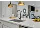 Bright kitchen island featuring a modern sink, stylish faucet, and elegant pendant lighting at 4040 Eaton Park St, Aurora, CO 80019